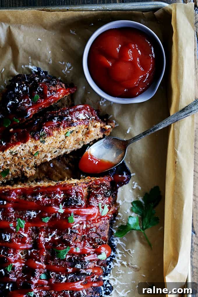 Turkey Meatloaf An overhead view of slices of Turkey Meatloaf with a bowl of ketchup and a spoon.