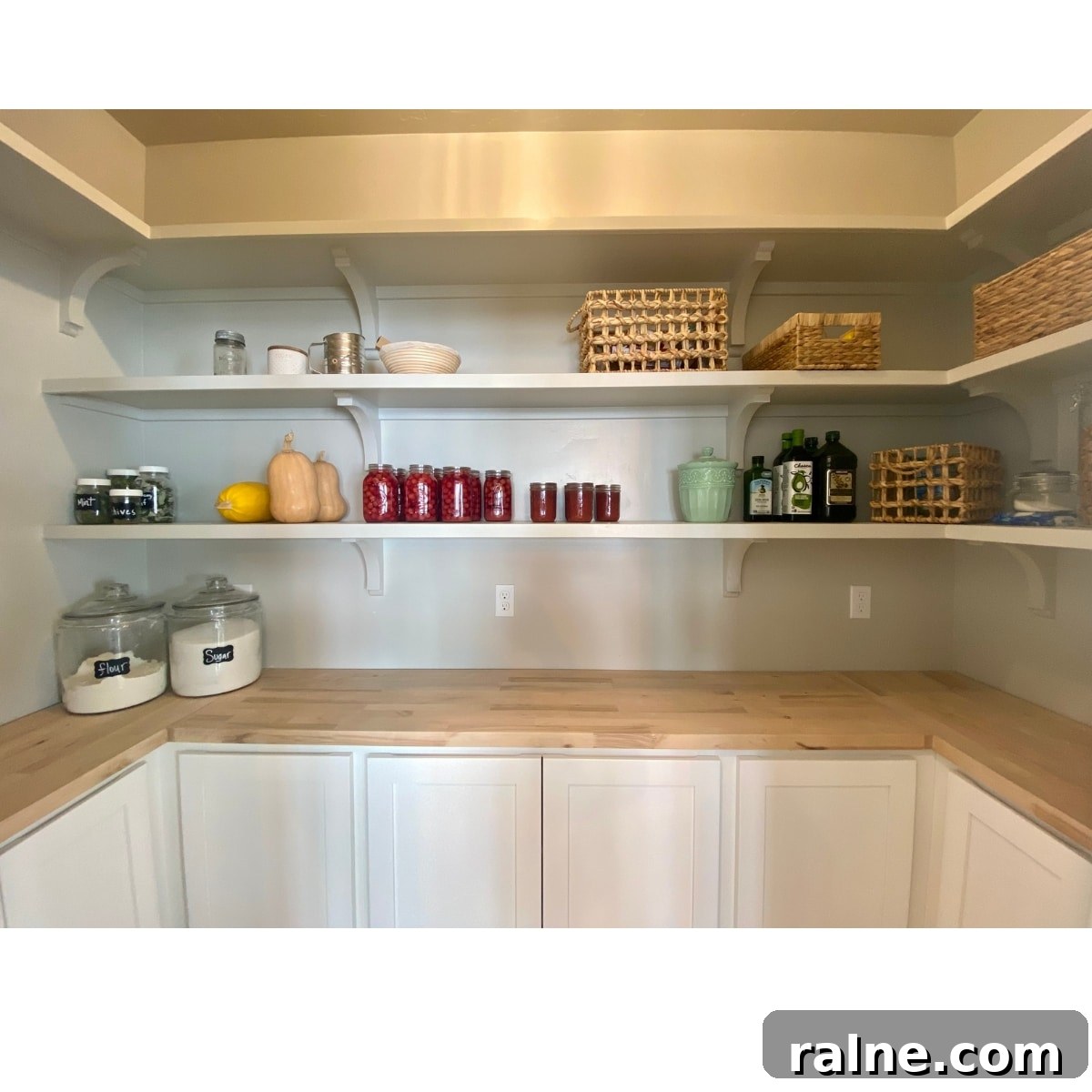 Create a Farmhouse Pantry You’ll Love: Stylish Storage Ideas 3 newly built farmhouse pantry with shallow cabinets and floating shelves a few baskets and jars and winter squash