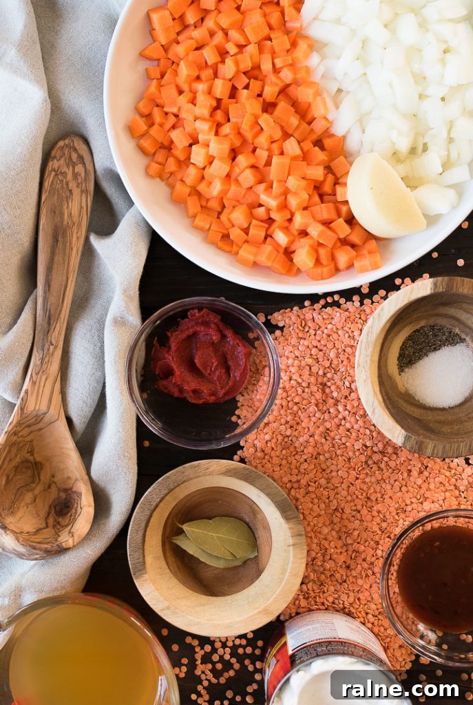 Creamy Coconut Red Lentil Soup with Warm Spices 3 ingredients to make red lentil soup in bowls on a wooden table