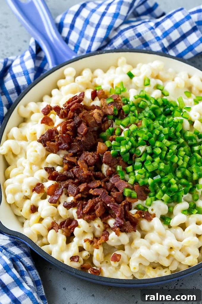 Jalapeño Popper Macaroni and Cheese Recipe 6 Macaroni and cheese in a skillet topped with bacon and diced jalapenos.