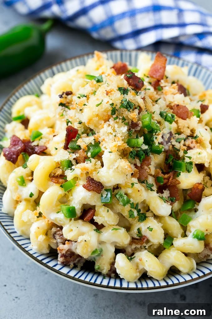 Jalapeño Popper Macaroni and Cheese Recipe 8 A bowl of jalapeno popper mac and cheese topped with crispy breadcrumbs, bacon and jalapeno peppers.