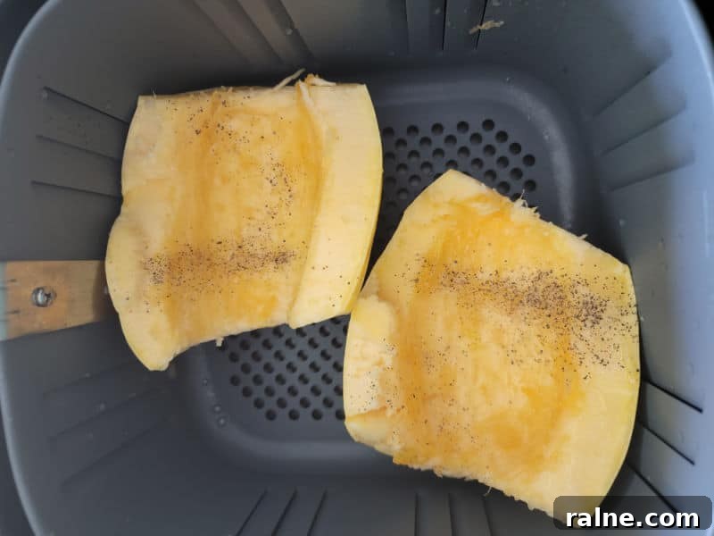 Crispy Air Fryer Spaghetti Squash with Garlic Parmesan 5 seasoned spaghetti squash in the air fryer basket