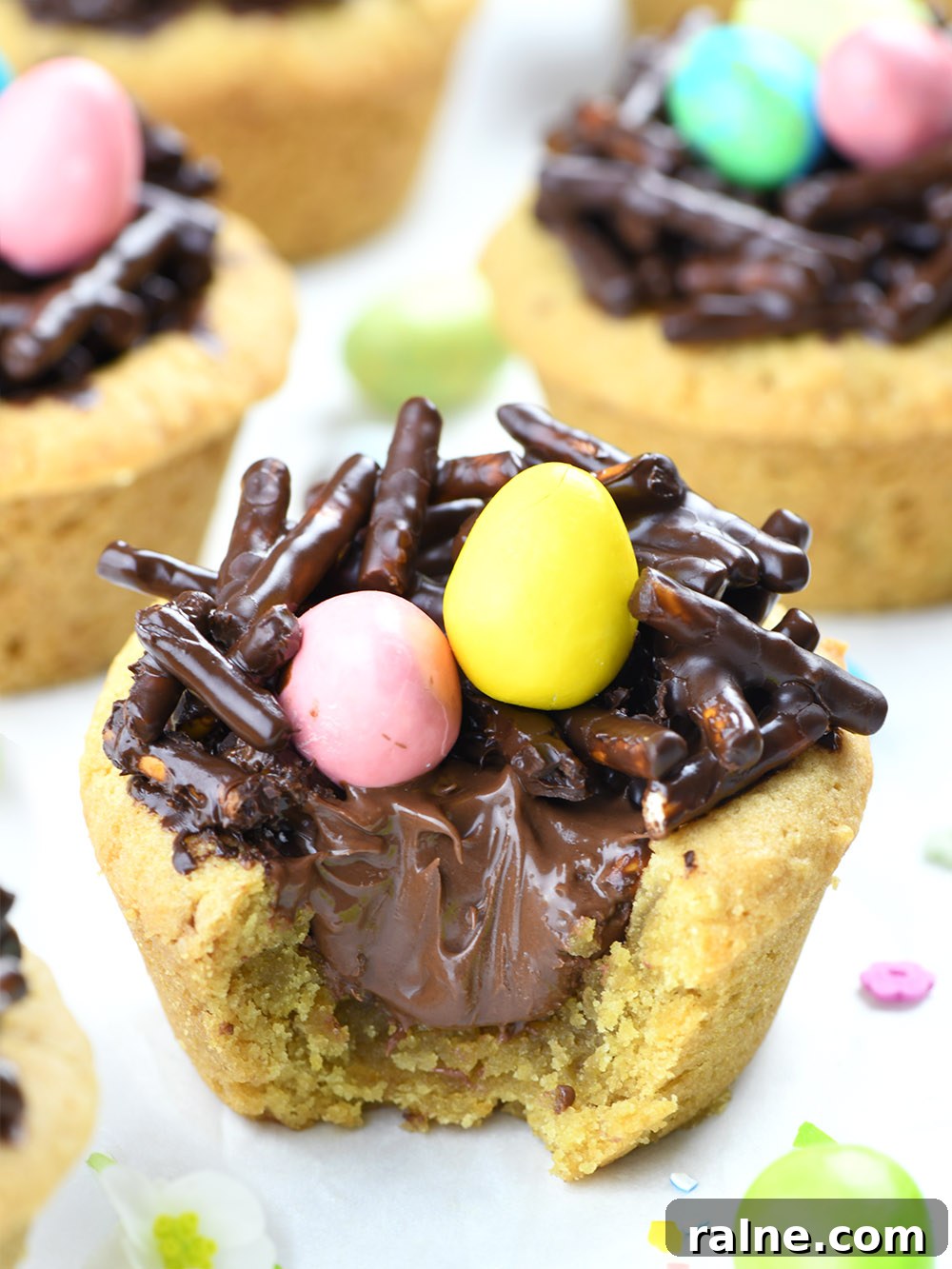 Bitten Cookie cup, filled with Nutella and Chocolate-Pretzel Nest with 2 easter eggs (candies) on the top.