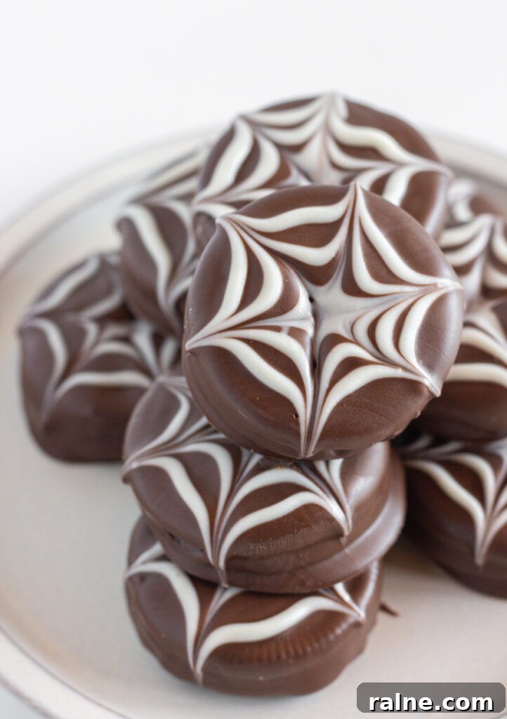 A plate of Halloween Chocolate Covered Oreos that look like spider webs.