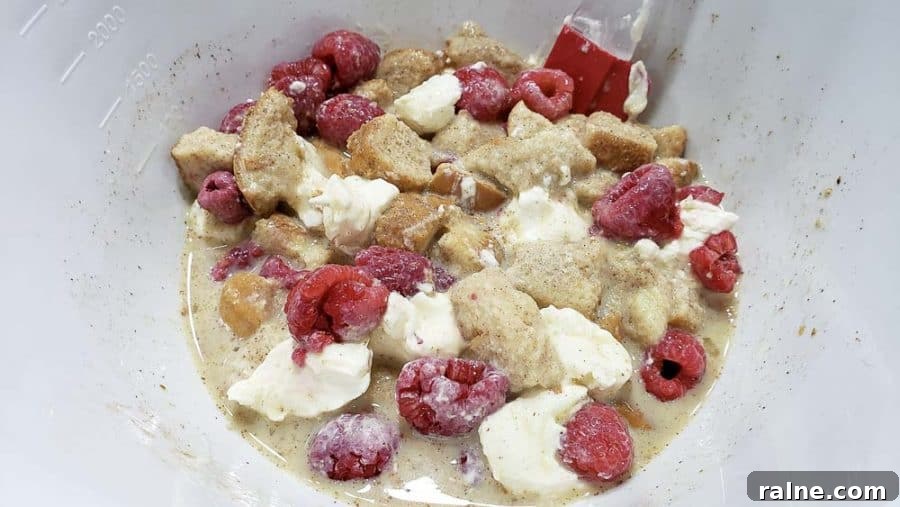 raspberries stirred into bowl with bread mixture.