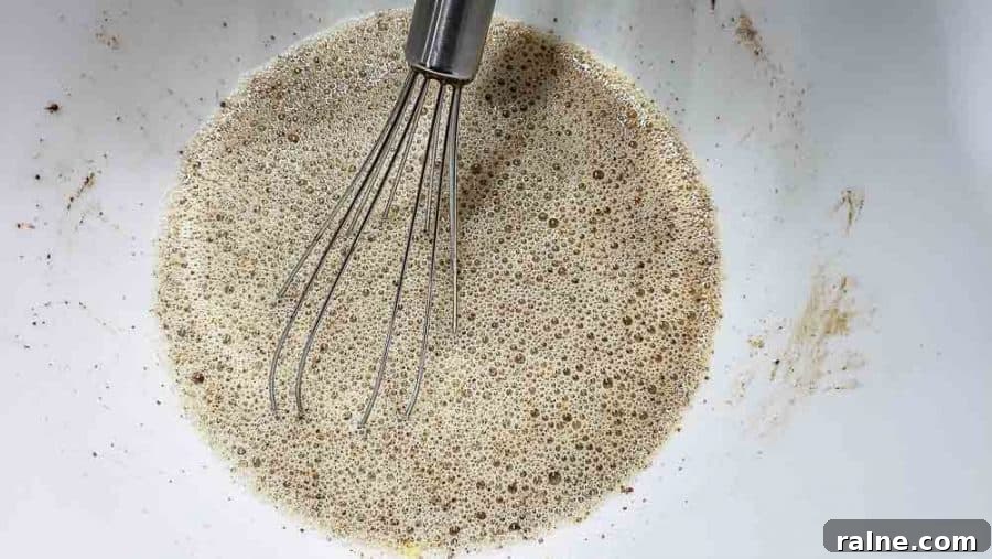 eggs, milk, cinnamon, brown sugar, and vanilla whisked in a bowl.