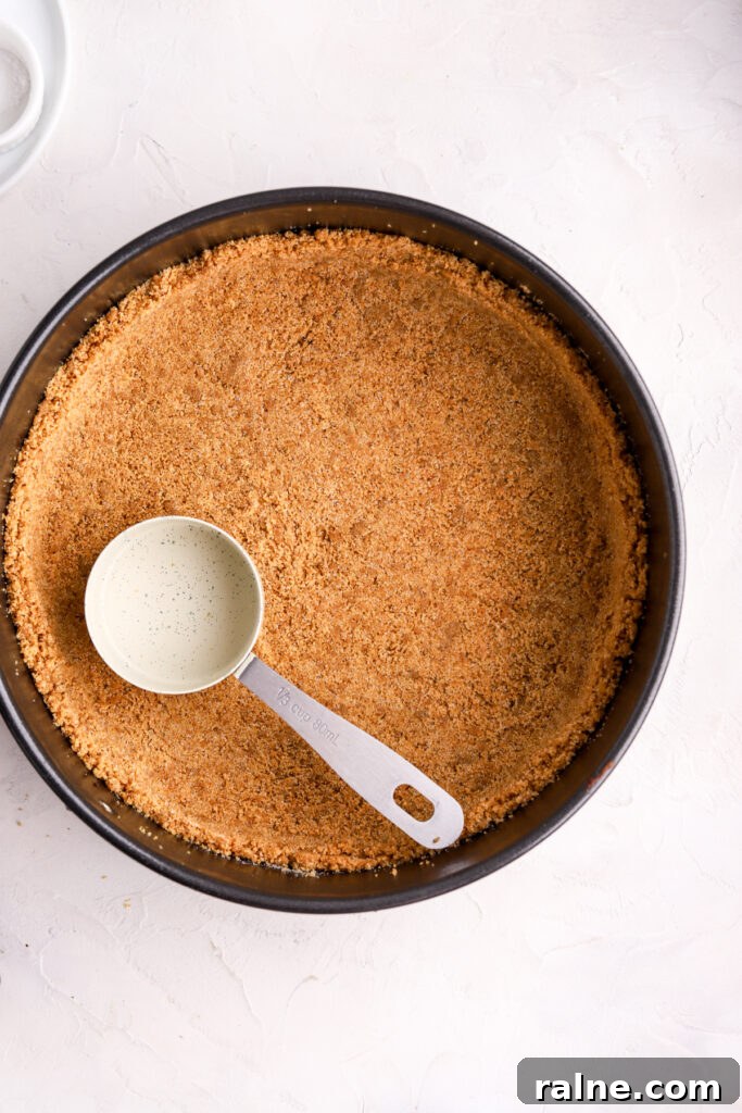 Pie-Inspired Birthday Cake Ideas for a Memorable Celebration 6 A springform pan with a graham cracker crust and a measuring cup on top.