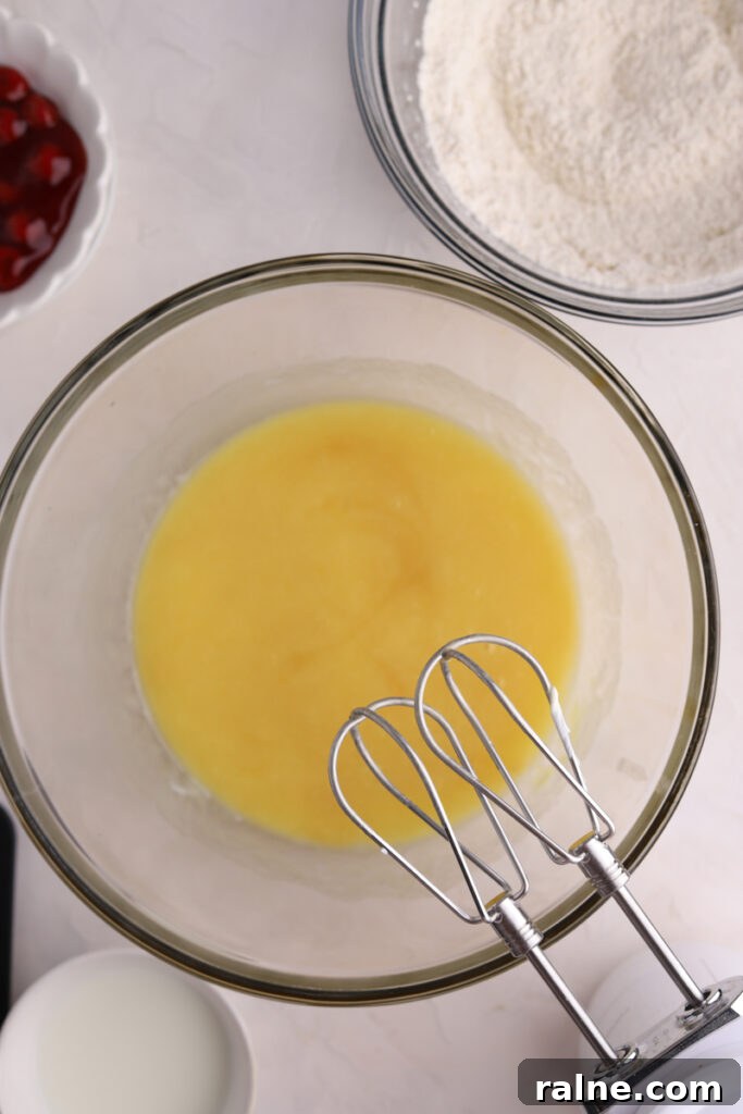 Pie-Inspired Birthday Cake Ideas for a Memorable Celebration 8 A glass mixing bowl with cake batter, a bowl of flour and a mixer.
