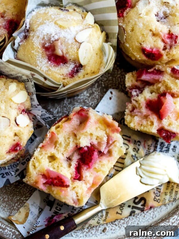 No-Bake Peanut Butter Cheerio Bars Recipe 9 Muffins on a plate with butter and strawberries.