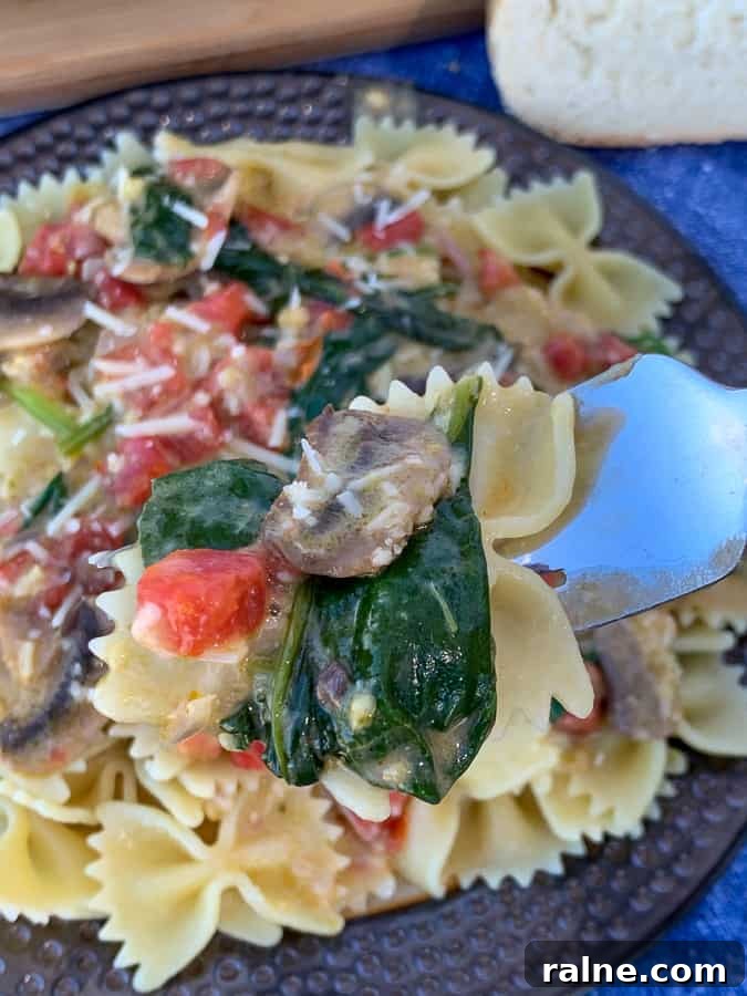 Fork full of copycat Macaroni Grill Pasta Milano over plate full