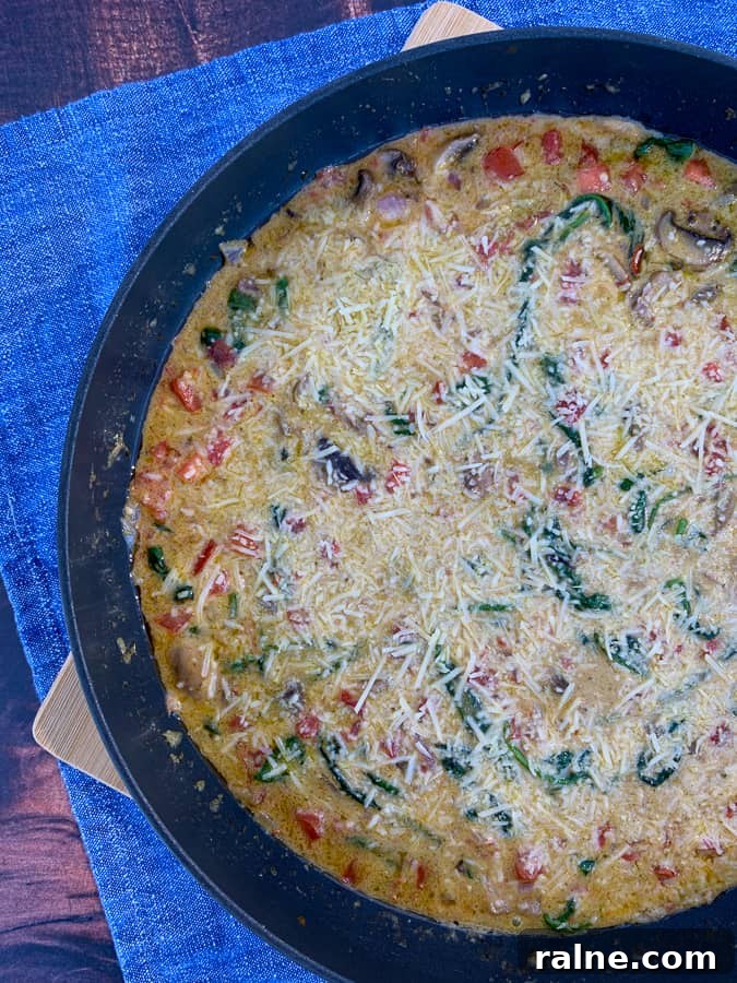 Skillet full of sauce with parmesan cheese for Macaroni Grill Pasta