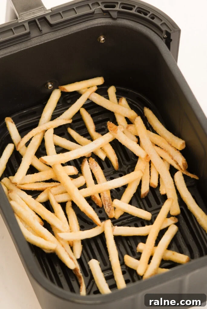 Frozen fast food style fries in the air fryer before cooking