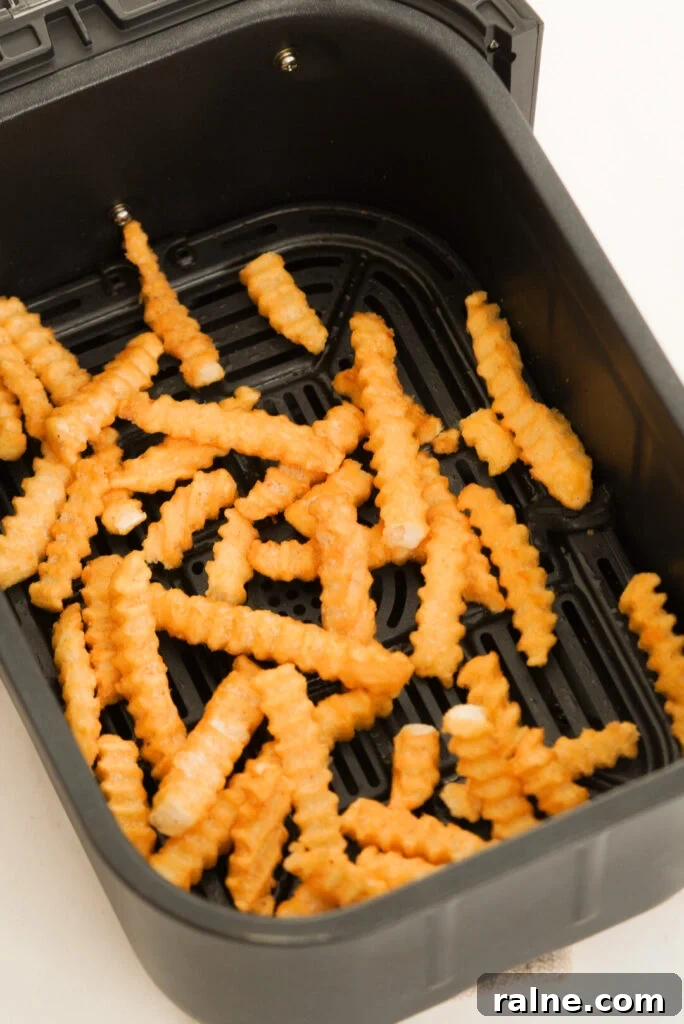 Frozen crinkle cut fries in the air fryer before cooking