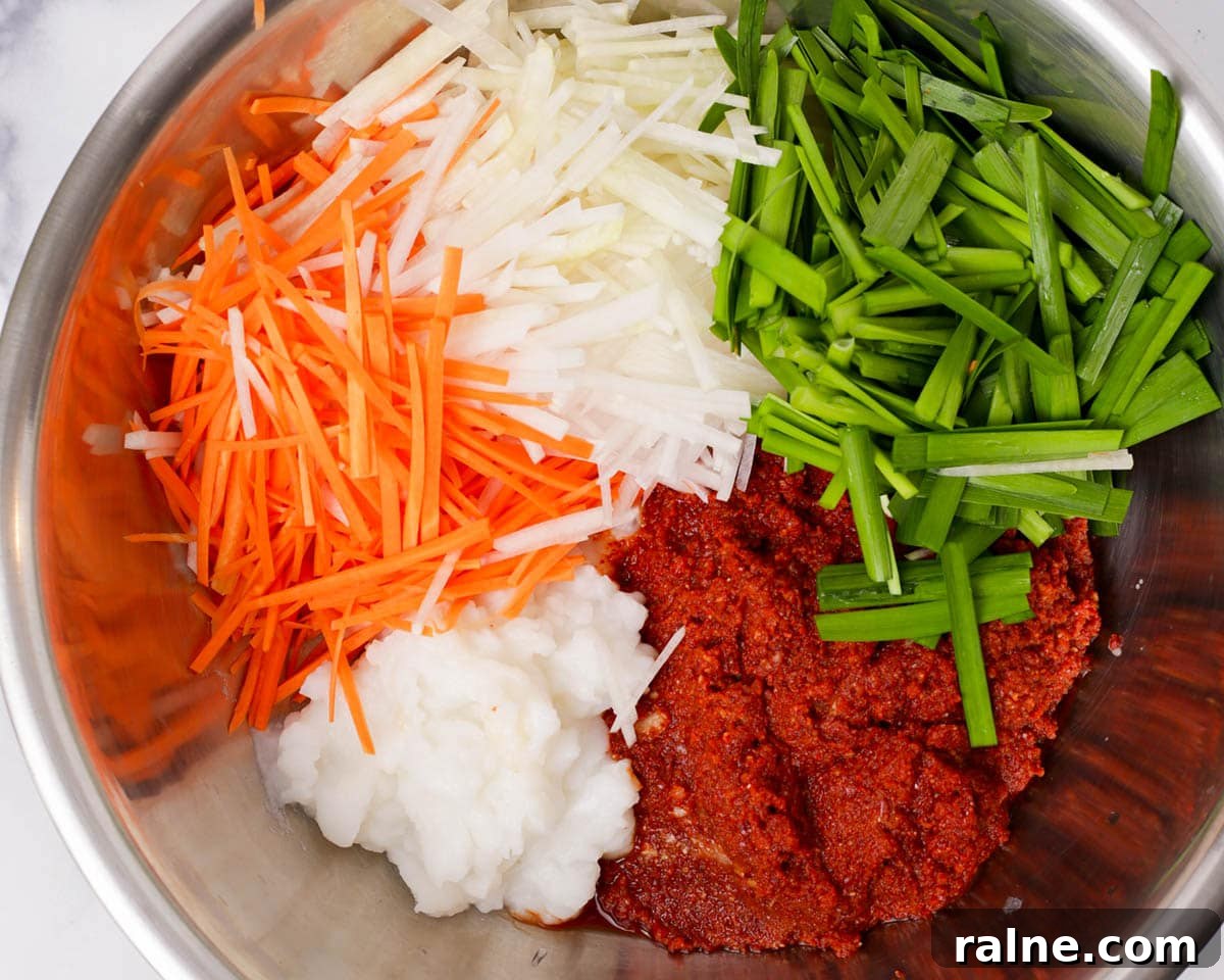 Napa Cabbage Kimchi Recipe: Authentic Homemade Kimchi Guide 21 kimchi marinade in bowl with vegetables.