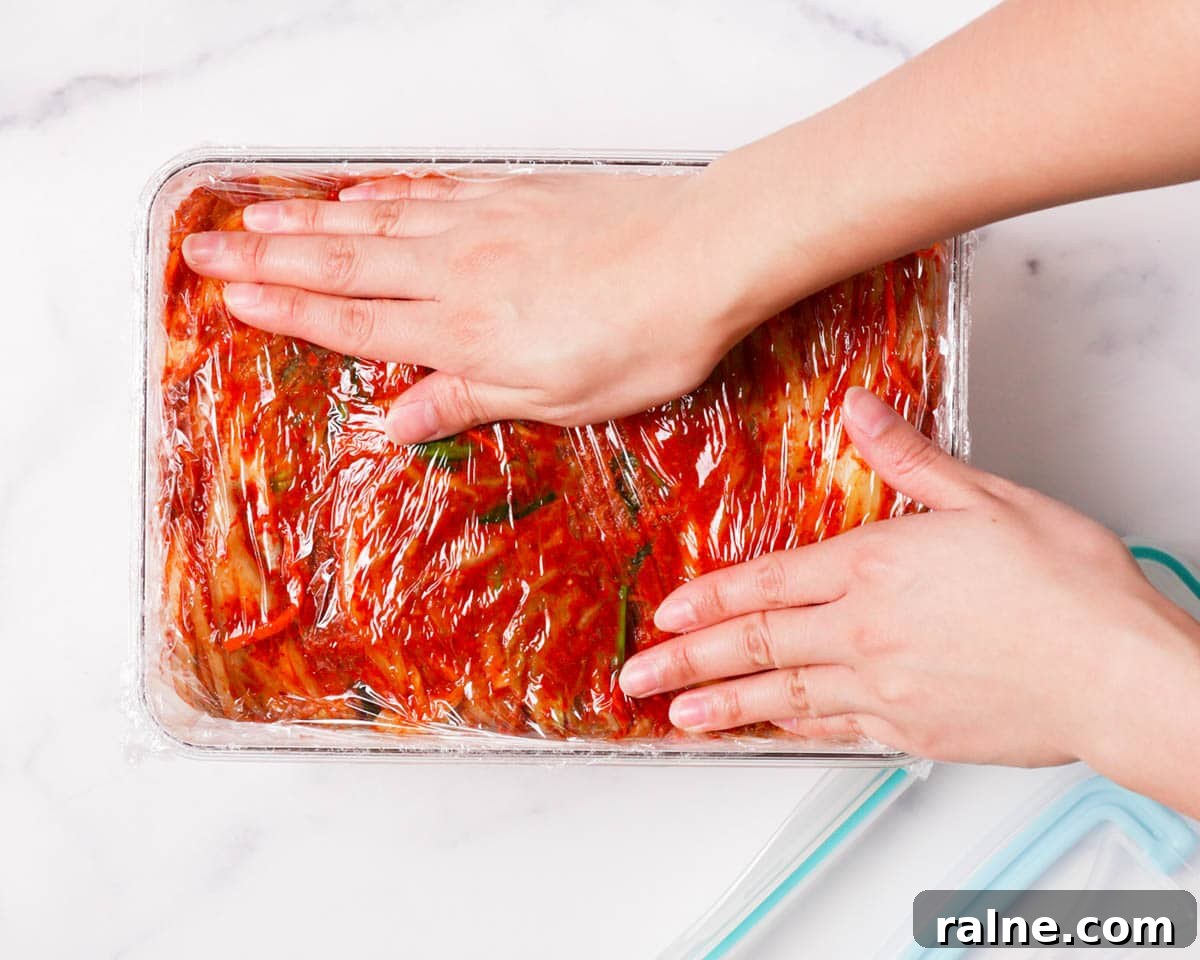 Napa Cabbage Kimchi Recipe: Authentic Homemade Kimchi Guide 27 Placing searn wrap on top of kimchi.