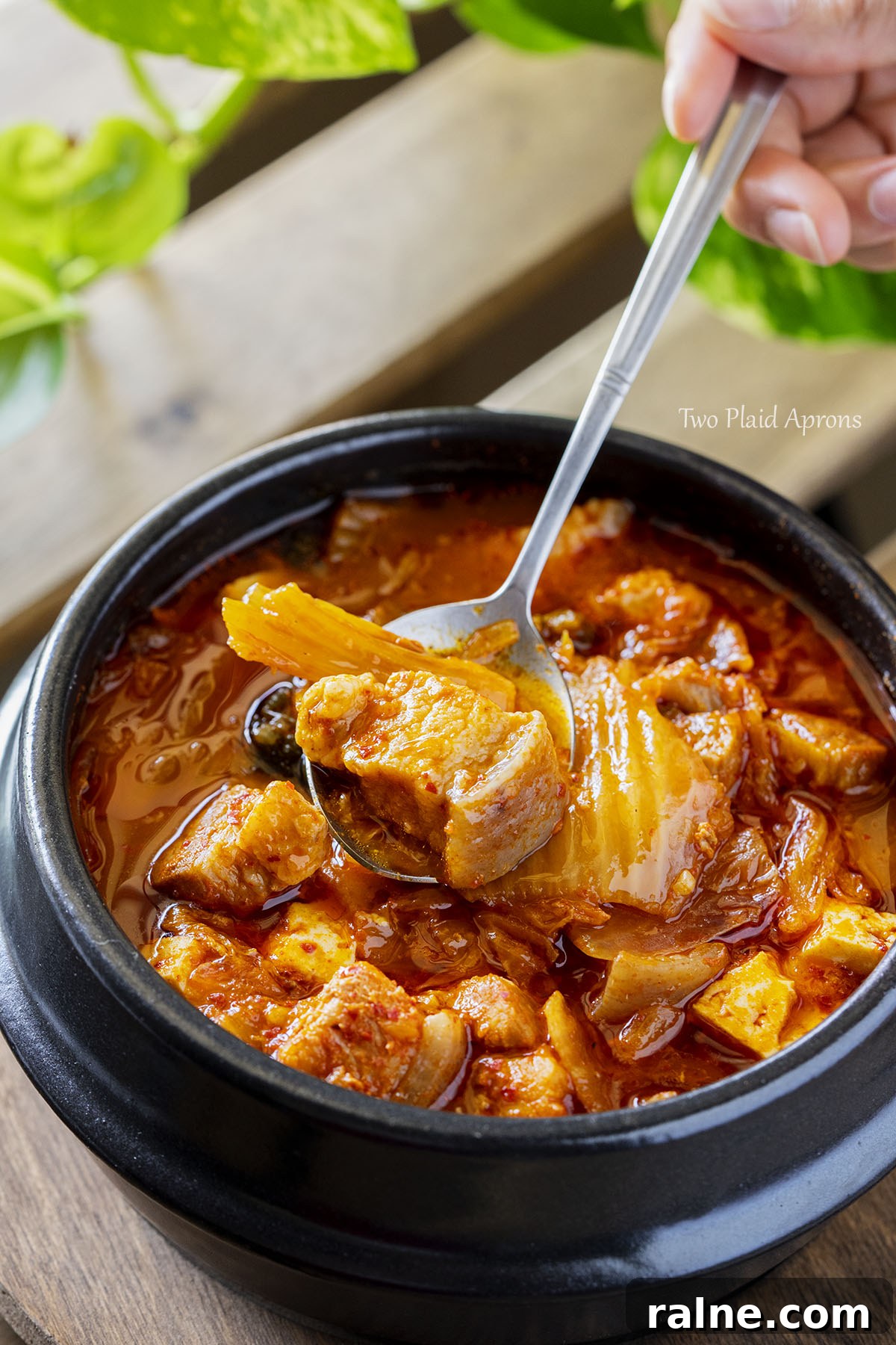Napa Cabbage Kimchi Recipe: Authentic Homemade Kimchi Guide 4 Top angled view of picking up a spoonful of Instant Pot kimchi jjigae.