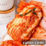 Napa Cabbage Kimchi Recipe: Authentic Homemade Kimchi Guide 31 Holding kimchi wrapped up thumbnail.