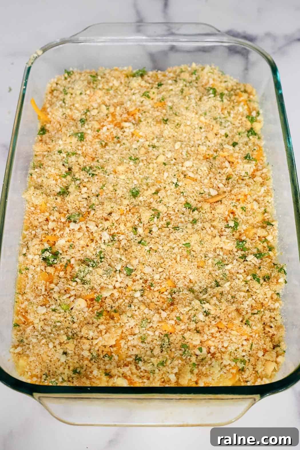 Old-Fashioned Baked Mac and Cheese with Ritz Cracker Topping 8 Casserole dish of mac and cheese fully layered with crushed Ritz crackers and parsley, prepped and ready for baking.
