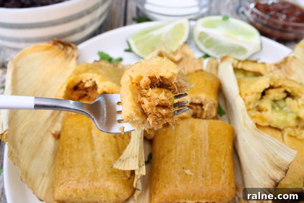holding up a fork with a piece of trader joes chicken tamale cooked in the air fryer