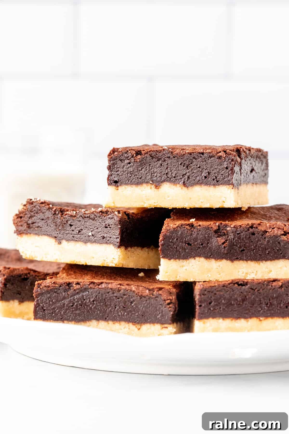Shortbread Brownies Recipe: Buttery Crust and Fudgy Center 3 Plate of shortbread brownies, stacked on top of each other.