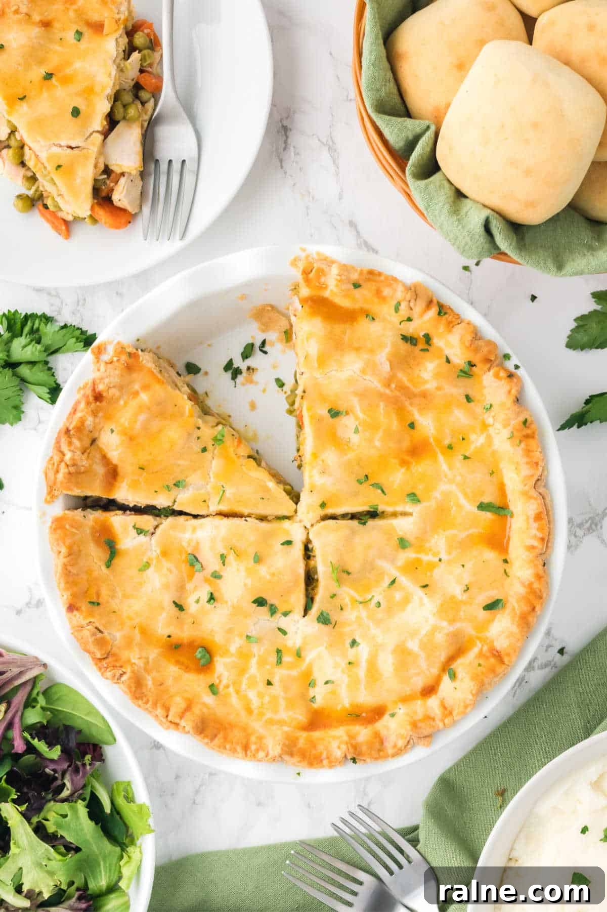 Homemade Chicken Pot Pie Recipe with Flaky Golden Crust 2 Chicken pot pie with a few slices cut.