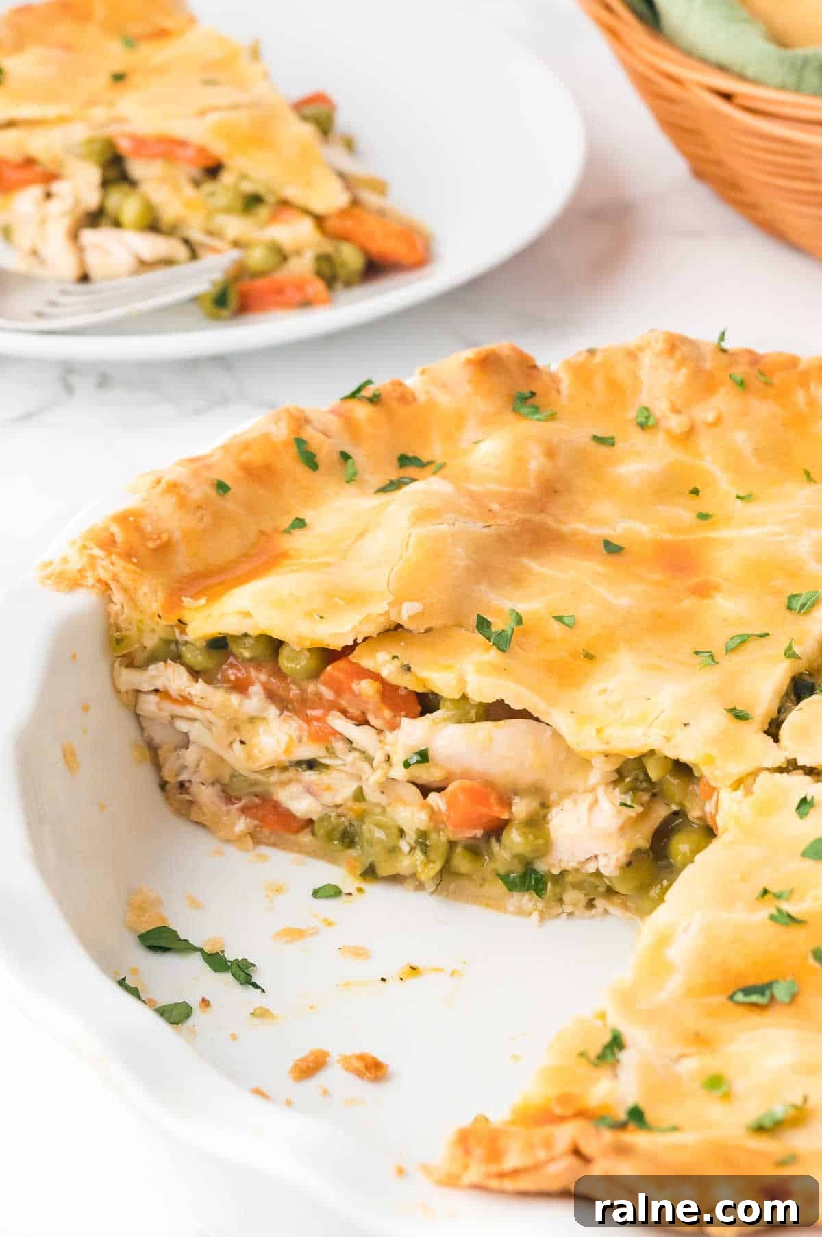 Homemade Chicken Pot Pie Recipe with Flaky Golden Crust 7 A chicken pot pie with pieces removed.