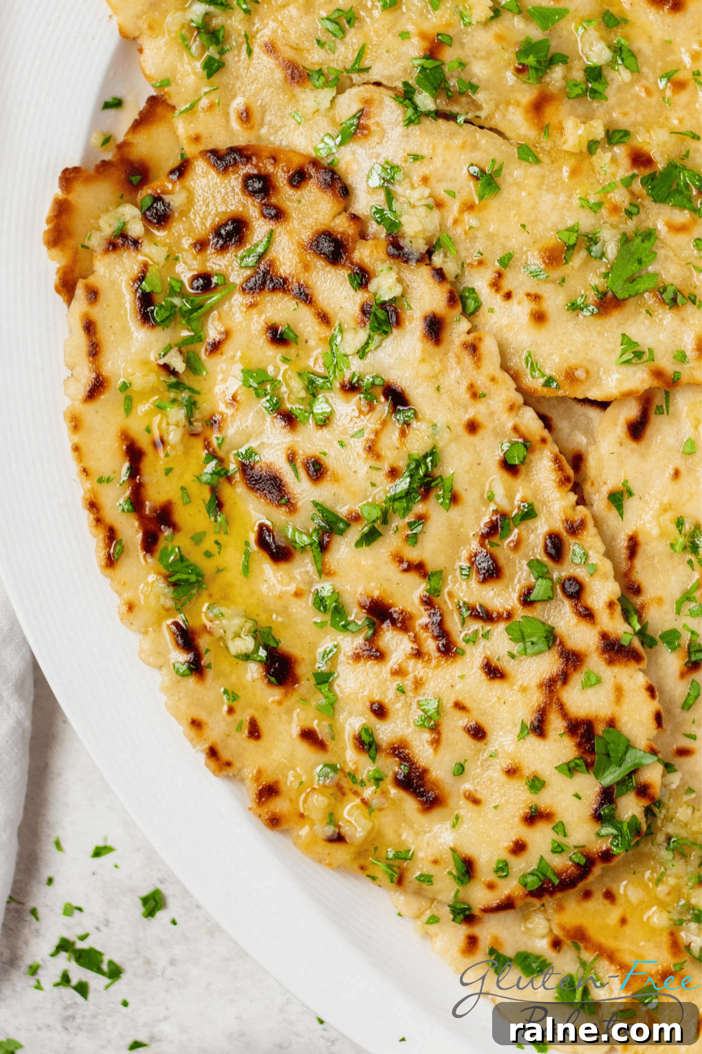 Gluten-Free Naan Recipe: Soft, Quick Homemade Flatbread 6 closeup view of a piece of gluten free naan on a plate