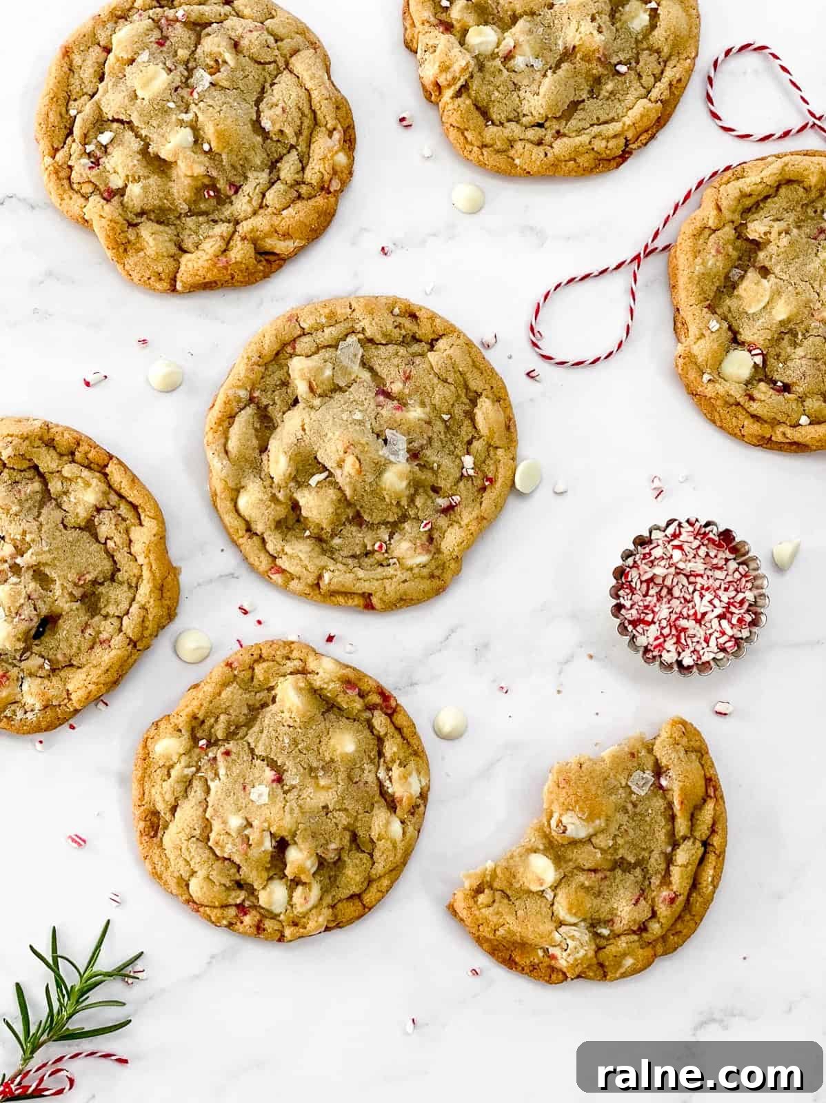 white chocolate peppermint pretzel cookies with one broken in half.