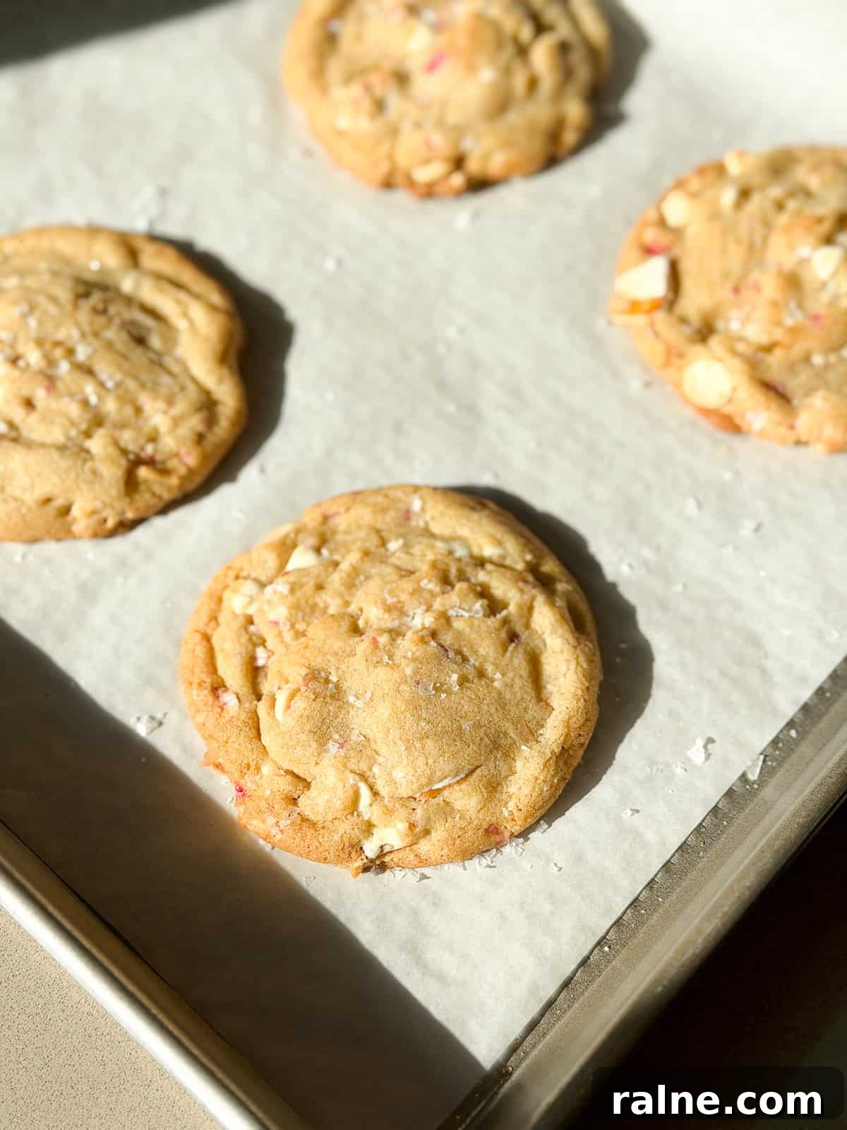 some of the white chocolate peppermint pretzel cookies on a baking sheet.