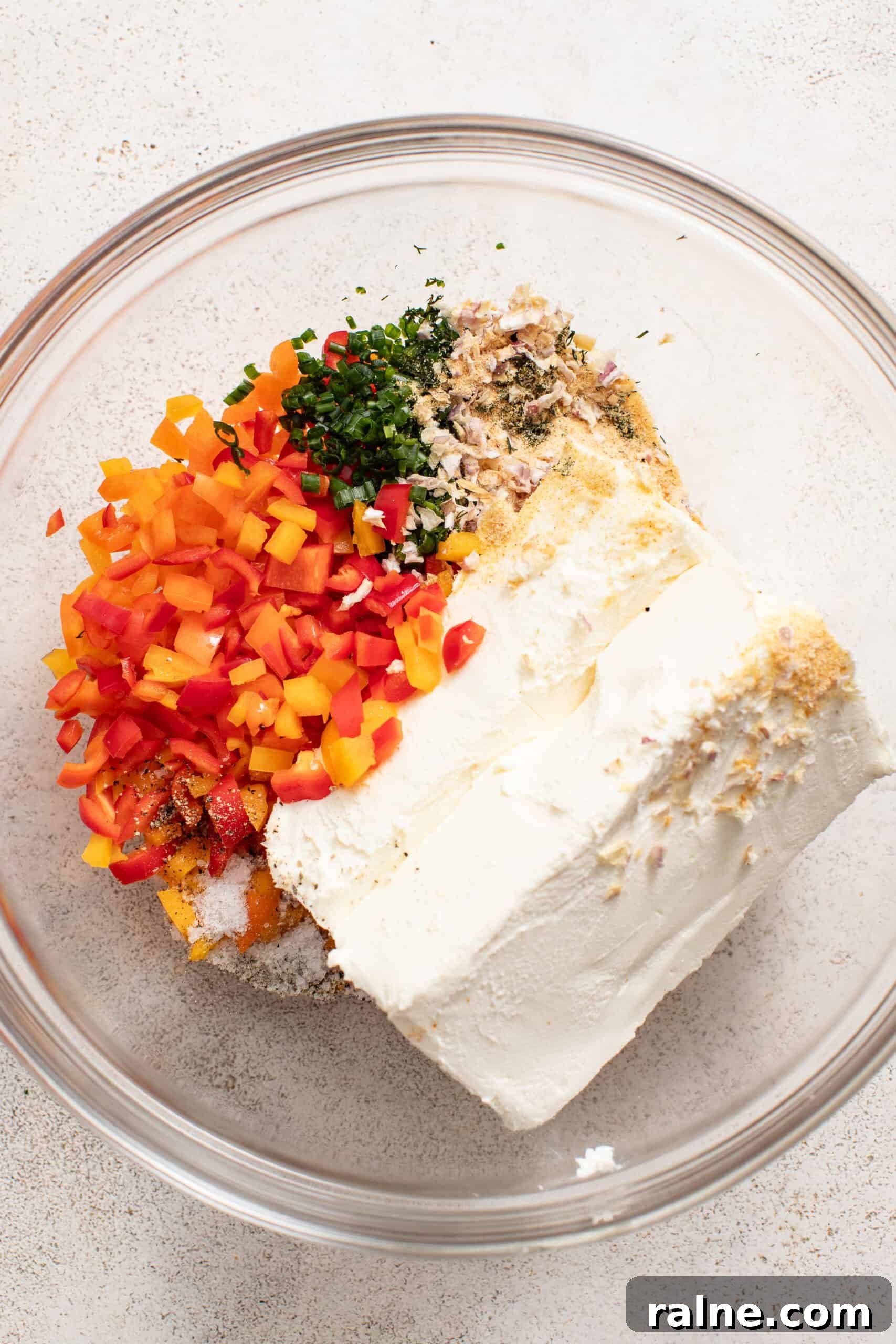 Cream Cheese Tortilla Roll-Ups: 5-Minute Party Appetizer Recipe 4 A bowl with chopped peppers, spices, and cream cheese.