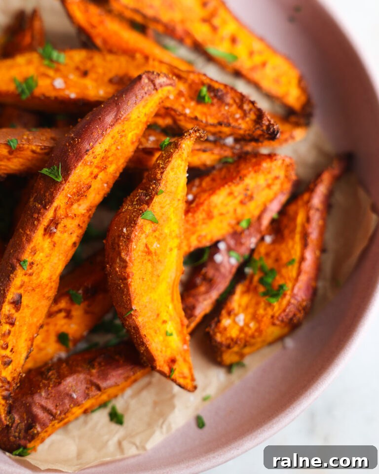 Delicious Sweet Potato Recipes for Every Meal 14 close up of sweet potato wedges on a pink plate