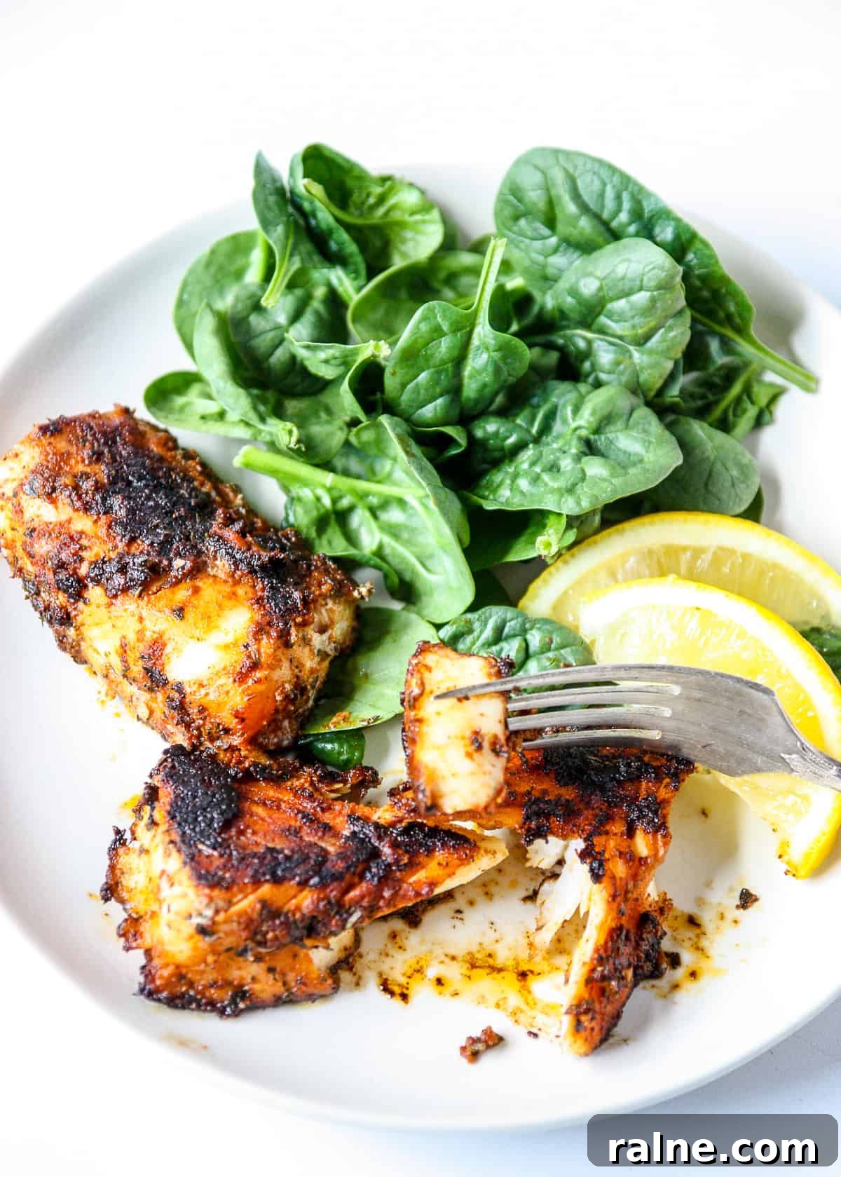 Cajun Blackened Cod Recipe — Crispy Spiced Pan-Seared Fish 7 A piece of fish on a fork.