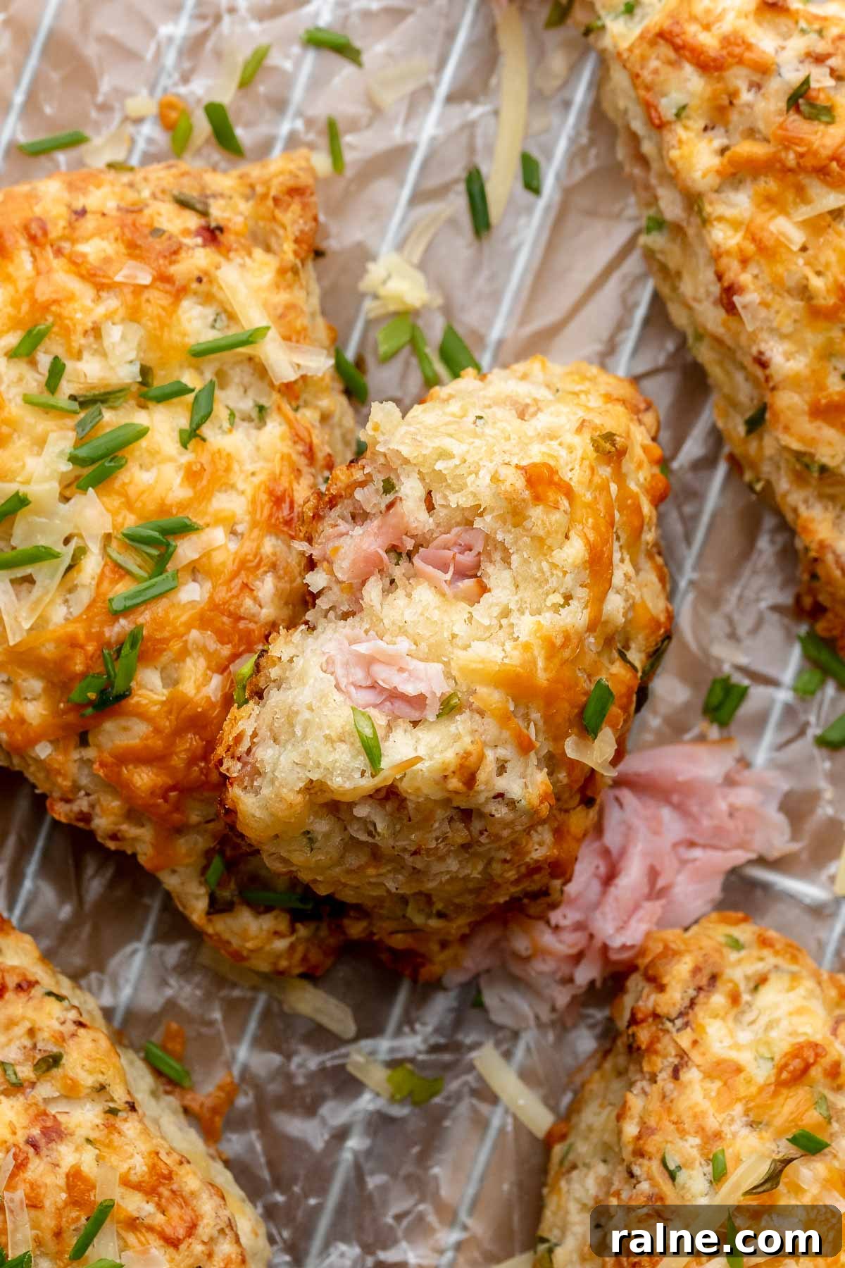 Savory Ham and Cheese Scones Recipe for Brunch or Snacks 2 A stack of ham and cheese scones. The top scone has a bite removed.
