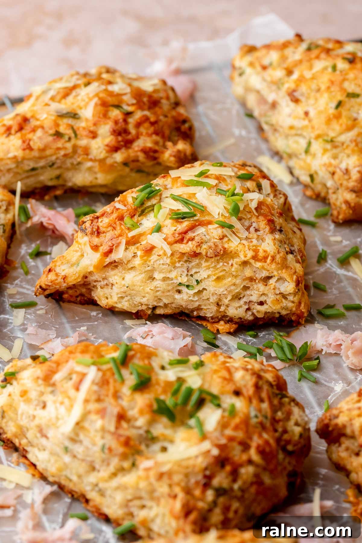 Savory Ham and Cheese Scones Recipe for Brunch or Snacks 12 Baked ham and cheese scones on parchment paper.