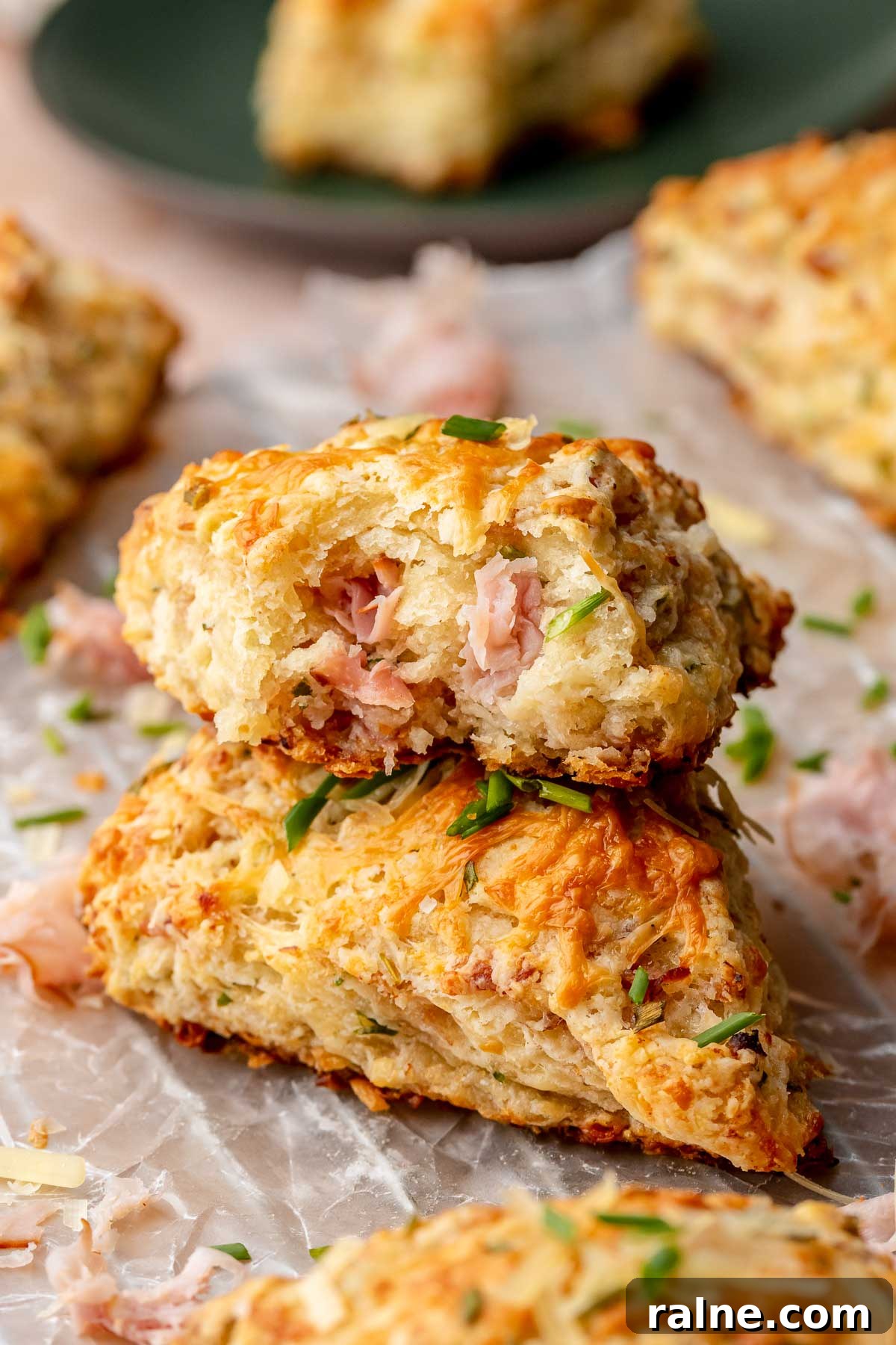 Savory Ham and Cheese Scones Recipe for Brunch or Snacks 13 A stack of ham and cheese scones. The top scone has a bite removed.