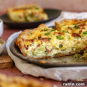Quiche slice in metal pie dish.