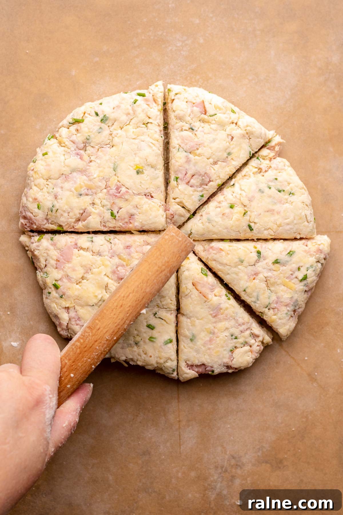 Savory Ham and Cheese Scones Recipe for Brunch or Snacks 9 A circle of scone dough gets cut into eight slices.