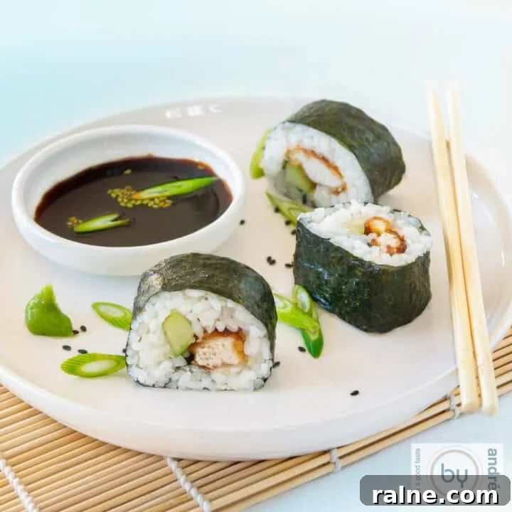 A square photo of 3 rolls of sushi with chicken and cucumber and soy sauce on a white plate.
