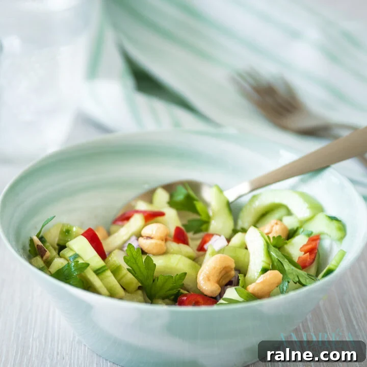a green bowl with Spicy cucumber salad