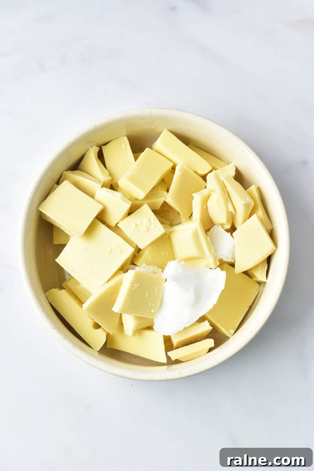 White Chocolate Almond Bark Recipe — Quick No-Bake Treat 5 white chocolate pieces and coconut oil in a bowl