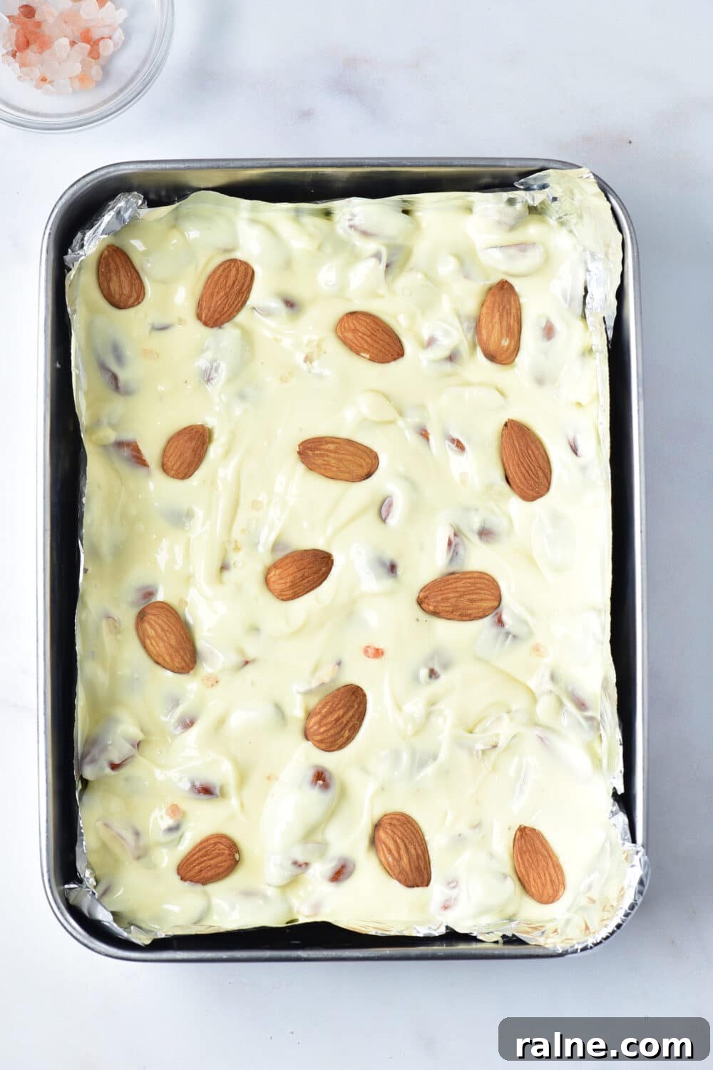 White Chocolate Almond Bark Recipe — Quick No-Bake Treat 9 Keto White Chocolate Almond Bark in a pan ready for freezer or fridge