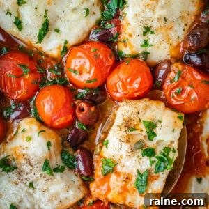 Baked cod in puttanesca sauce with cherry tomatoes, olives, capers and garnished with parsley.