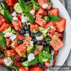 Watermelon blueberry feta salad with fresh mint and cucumber in a serving bowl.