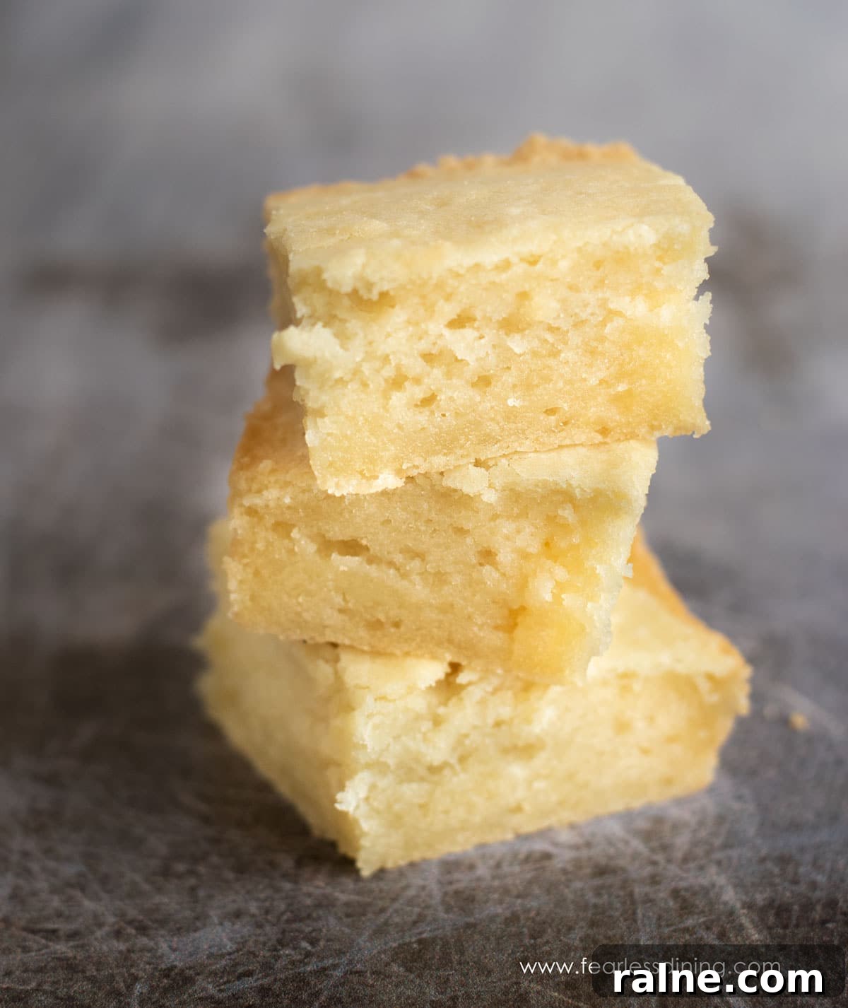 Classic Hawaiian Butter Mochi Recipe for Perfect Chewy Dessert 2 Three pieces of butter mochi stacked on top of each other.