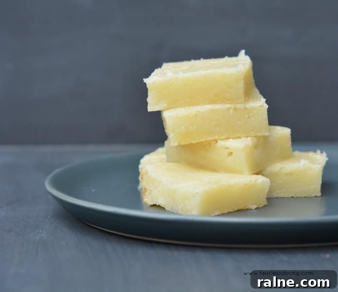 Classic Hawaiian Butter Mochi Recipe for Perfect Chewy Dessert 7 Hawaiian Bata - Hawaiian Butter Mochi squares stacked on a grey plate.