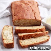 A partially sliced loaf of crusty keto bread.