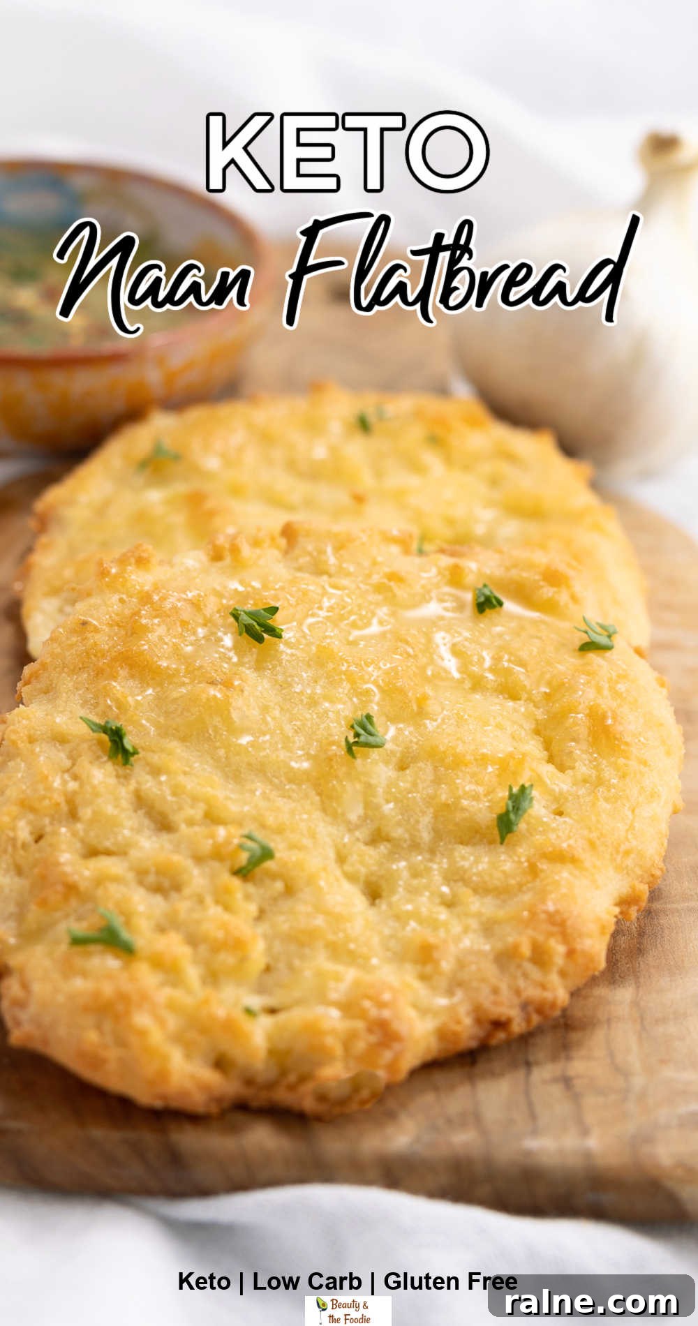 Keto-Friendly Naan Flatbread Recipe: Low-Carb Indian-Style Bread 3 keto naan flatbread on a cutting board witha bowl of oil and herbs behind it.