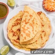 A folded keto tortilla on top of other tortillas.