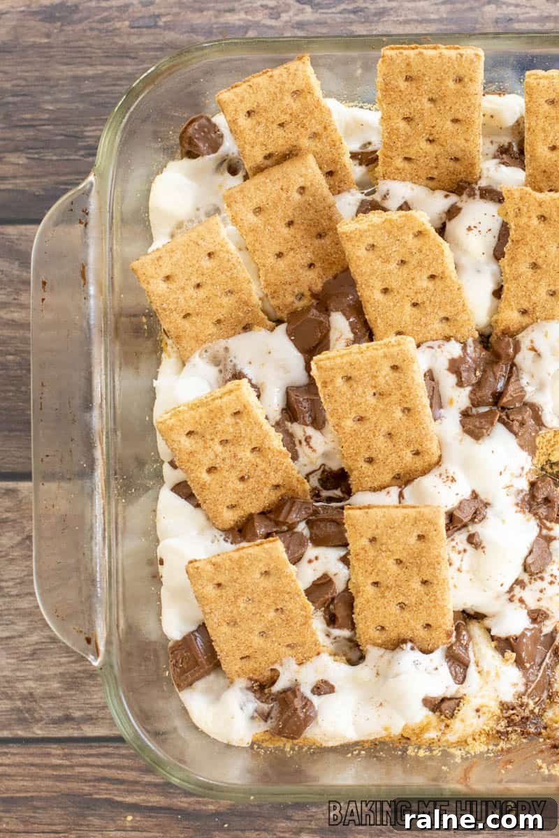Decadent S'mores Casserole Recipe for Family Desserts 3 graham crackers stuck into the smores casserole recipe