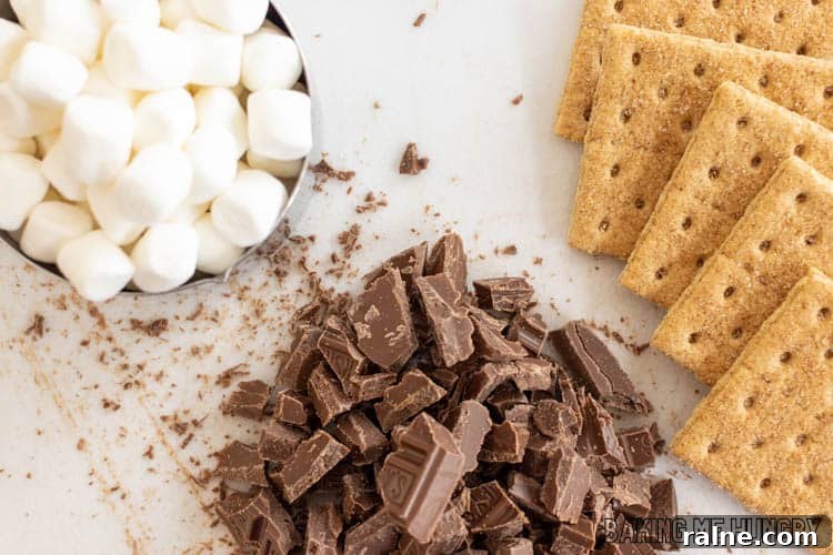 Decadent S'mores Casserole Recipe for Family Desserts 5 chopped chocolate next to mini marshmallows and graham crackers